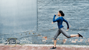 A determined woman running outdoors in athletic wear, symbolizing health and fitness, with Body Bar MD branding.