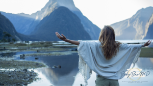 A woman with outstretched arms facing a serene mountain landscape, symbolizing freedom, balance, and wellness, with the Body Bar MD logo.