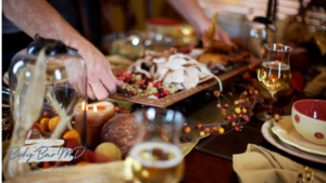 Close-up of a festive holiday dinner table with a hand carving turkey, surrounded by colorful decorations and warm candlelight, featuring the Body Bar MD logo in the foreground.