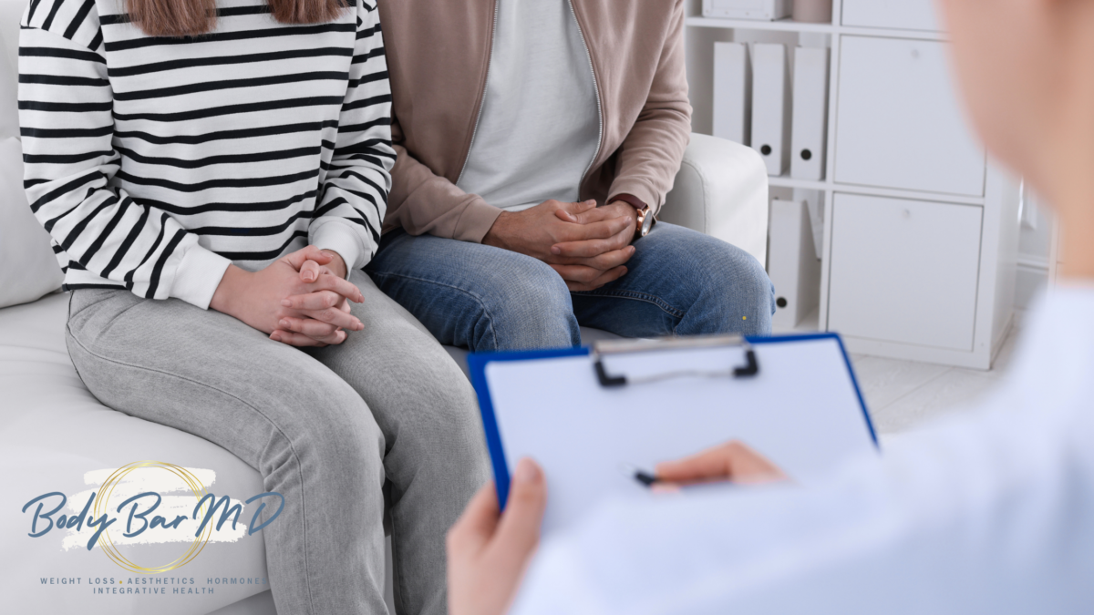 Couple sitting together during a consultation, symbolizing supportive and compassionate healthcare services at Body Bar MD.