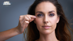 A close-up of a woman with youthful skin, highlighting anti-aging treatments as hands gently examine her face.