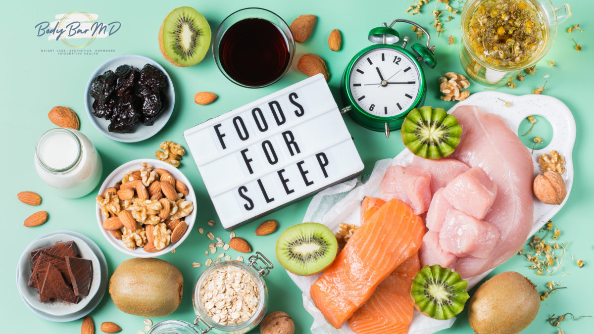 A selection of sleep-friendly foods, including salmon, kiwi, nuts, and chamomile tea, arranged with a clock and a "Foods for Sleep" sign.