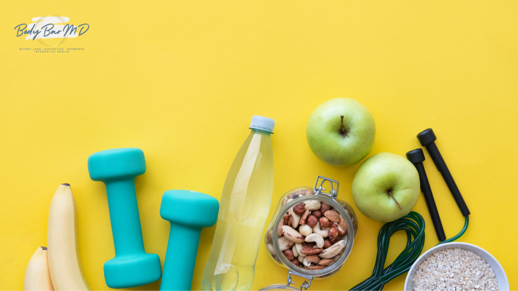 A collection of healthy lifestyle essentials, including fruits, nuts, a water bottle, dumbbells, and a jump rope