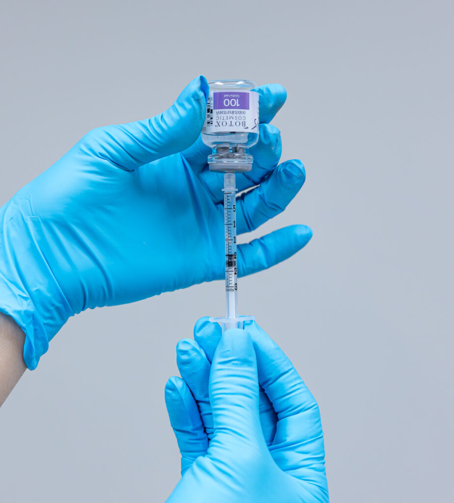 A pair of gloved hands prepare an injection of Botox in Carmel, IN