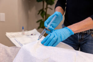 A provider makes a hormone injection for a patient needing regenerative medicine in Carmel, IN