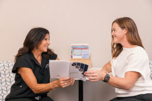 Patients smile and laugh as they talk about weight loss support in Carmel, IN.