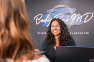 A provider smiles as she checks in a patient for hormone balance in Terre Haute, IN.