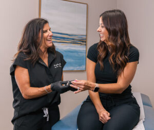 A provider and a patient smile during a consultation hormone replacement therapy for perimenopause in Carmel, IN