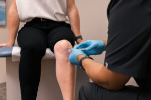 A gloved provider makes an injection in an inflamed joint as a part of the regenerative medicine in Carmel, IN