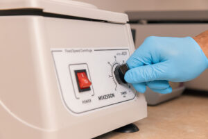 A provider spins a centrifuge as a part of the process for regenerative medicine in Carmel, IN